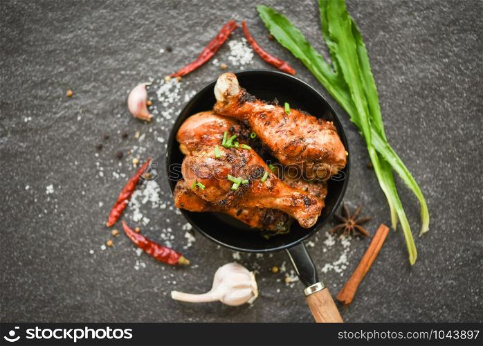 Grilled chicken legs barbecue with herbs and spices / Tasty roasted chicken legs on the pan with ingredients cooking food