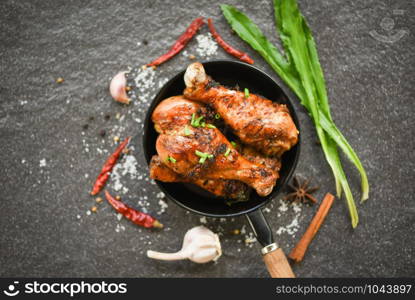Grilled chicken legs barbecue with herbs and spices / Tasty roasted chicken legs on the pan with ingredients cooking food