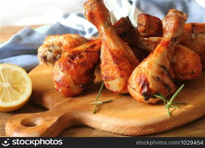 Grilled chicken legs on cutting board.Rustic background .. Grilled chicken legs on cutting board. Rustic background