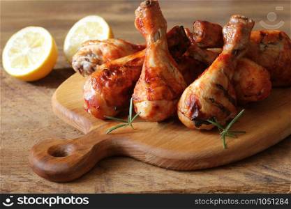 Grilled chicken legs on cutting board.Rustic dinner background .. Grilled chicken legs on cutting board.Rustic dinner background