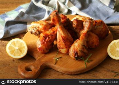 Grilled chicken legs on cutting board.Rustic dinner background .. Grilled chicken legs on cutting board.Rustic dinner background