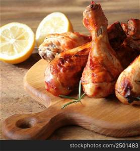 Grilled chicken legs on cutting board. Rustic dinner background .. Grilled chicken legs on cutting board. Rustic dinner background