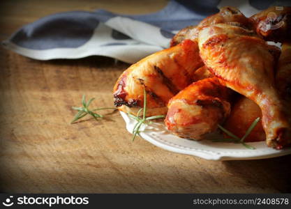 Grilled chicken legs on white plate .Rustic dinner background .. Grilled chicken legs on white plate .Rustic dinner background