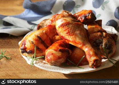 Grilled chicken legs with rosemary served on white plate. Dinner background .. Grilled chicken legs with rosemary served on white plate. Dinner background