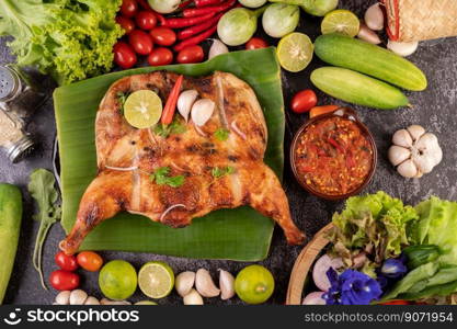 Grilled chicken on a plate with sticky rice, chilies, garlic sauce and sprinkled with pepper seeds