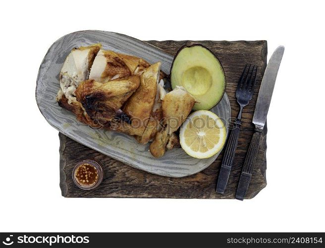 Grilled chicken or Roasted chicken with Avocado and Lemon cut in half serve with Sweet chili sauce isolated on white background with clipping path. Selective focus.