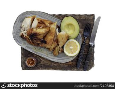 Grilled chicken or Roasted chicken with Avocado and Lemon cut in half serve with Sweet chili sauce isolated on white background with clipping path. Selective focus.