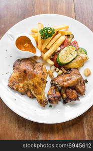 grilled chicken peri peri, BBQ Portuguese groumet griled cuisine, with fries and grilled vegetable.