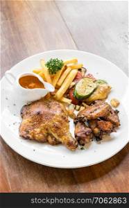 grilled chicken peri peri, BBQ Portuguese groumet griled cuisine, with fries and grilled vegetable.