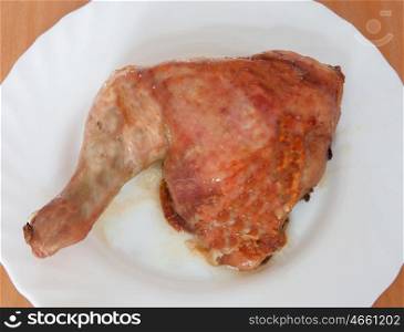 Grilled chicken thigh on a white plate