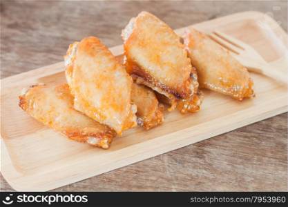 Grilled chicken wings on wooden plate, stock photo