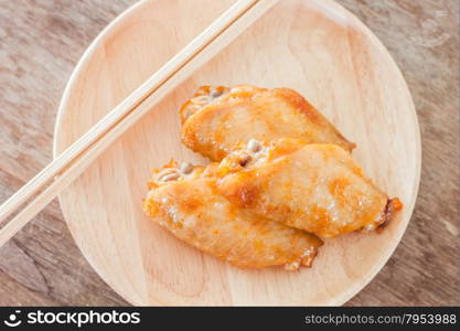 Grilled chicken wings on wooden plate, stock photo