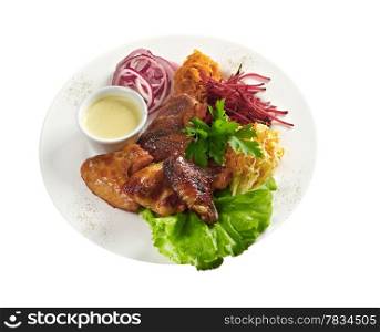 Grilled chicken wings with vegetable closeup