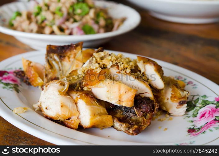 Grilled chicken with fried garlic on dish