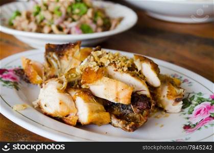 Grilled chicken with fried garlic on dish