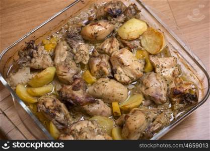 grilled chicken with potatoes, on wooden table