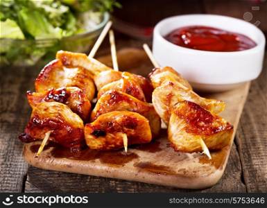 grilled chicken with salad on wooden board