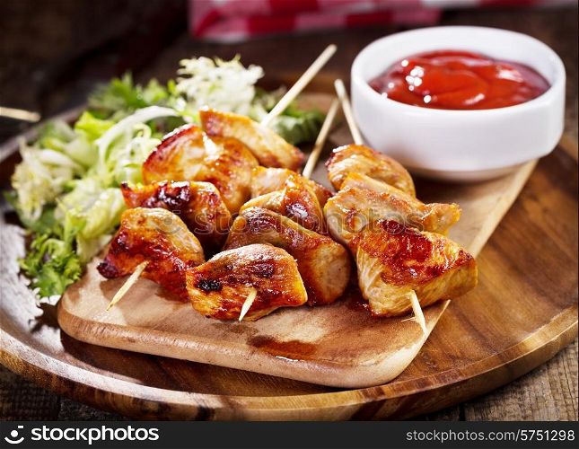 grilled chicken with salad on wooden plate
