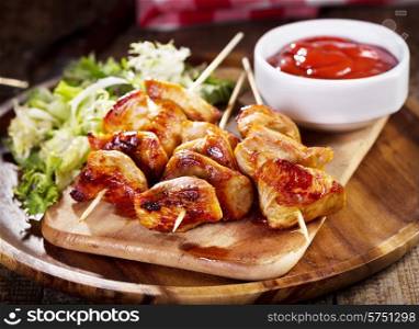 grilled chicken with salad on wooden plate