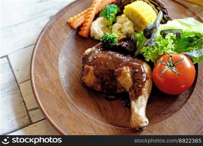 grilled chicken with vegetable on wooden plate