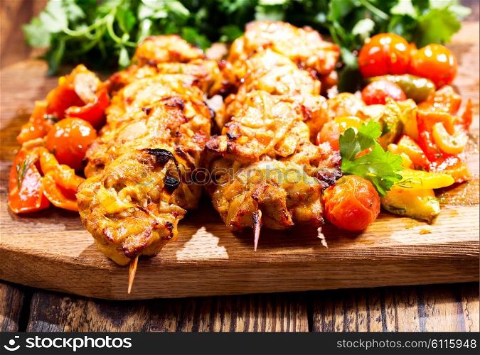 grilled chicken with vegetables on wooden board