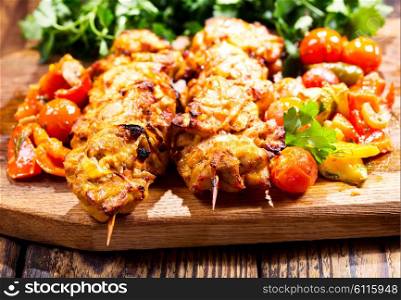 grilled chicken with vegetables on wooden board