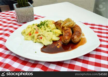 Grilled country sausages served with potatoes in salted . Grilled country sausages served with potatoes in salted and onion at Hofgut Sternen in the Black Forest in Germany