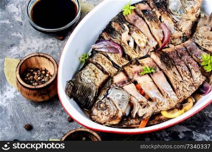 Grilled delicious fish.Baked fish with citrus,vegetable and spices in baked fish.Seafood. Carp stuffed with vegetables
