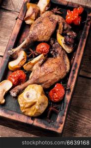 Grilled duck legs baked with apples and vegetables. Dietary meat. Baked duck leg