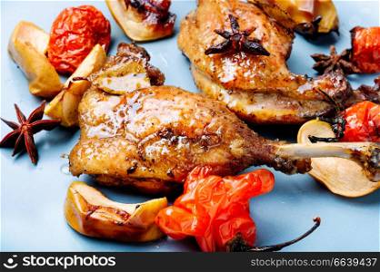 Grilled duck legs baked with apples and vegetables. Dietary meat.Cooking at Christmas time. Duck legs with vegetable garnish