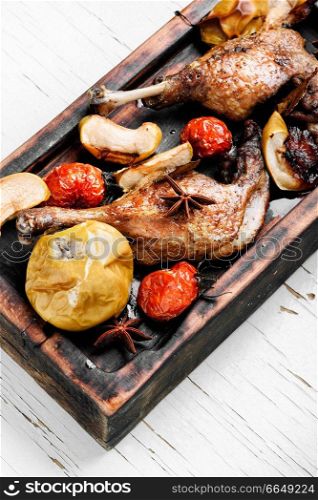 Grilled duck legs baked with apples and vegetables. Dietary meat. Duck legs with vegetable garnish