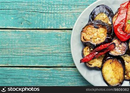 Grilled eggplant and grilled bell pepper on on wooden background. Top view with copy space. Grilled vegetables, recipe place