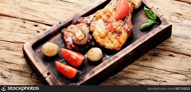 Grilled fillet steak. Grilled meat steak,tomato, herbs and spices on cutting board