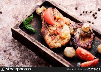 Grilled fillet steak. Grilled meat steak,tomato, herbs and spices on cutting board