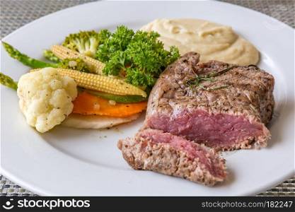 grilled fillet steak served with grilled vegetable and mash potato