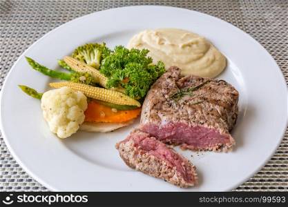 grilled fillet steak served with grilled vegetable and mash potato
