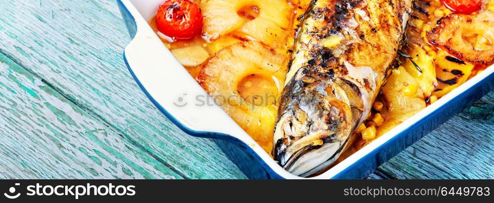 Grilled fish in pineapple sauce. Roasted fish with pineapple sauce in baking dish