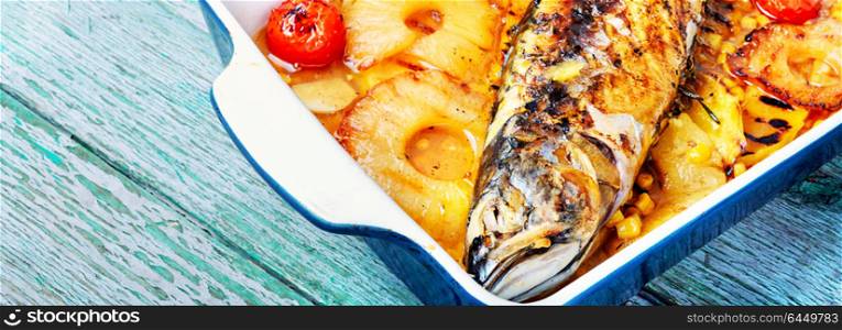 Grilled fish in pineapple sauce. Roasted fish with pineapple sauce in baking dish