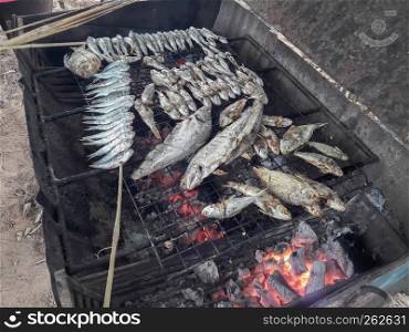 Grilled fish on charcoal stove