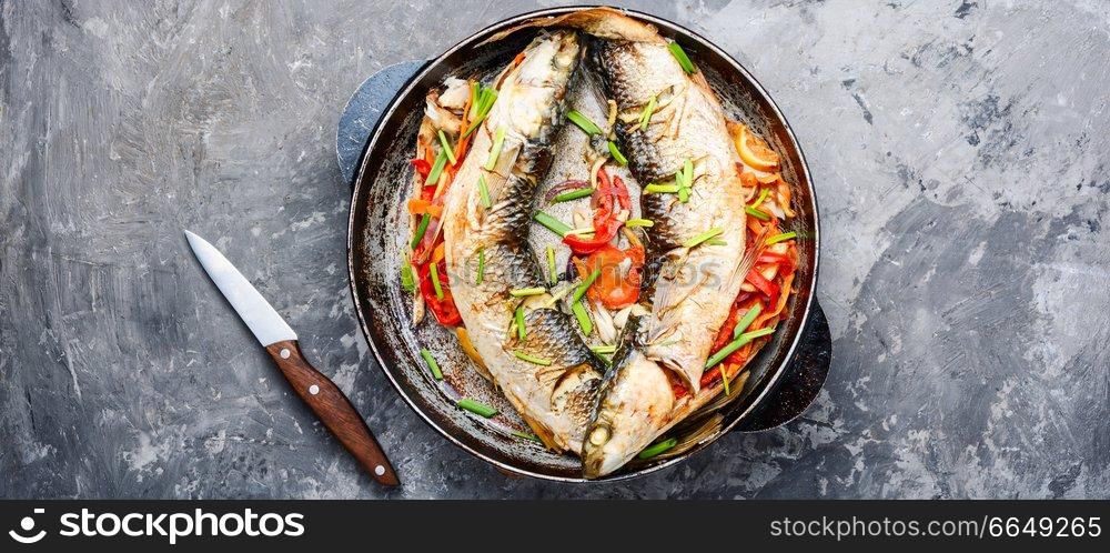 Grilled fish stuffed with different vegetables.Seafood.Baked pelengas. Appetizing baked fish