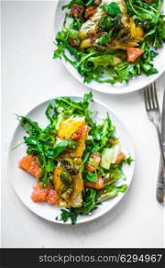 Grilled fish with arugula salad