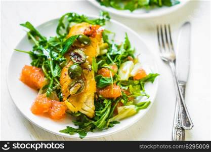 Grilled fish with arugula salad