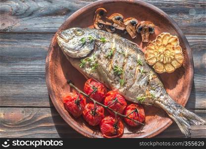 Grilled fish with thyme and cherry tomatoes
