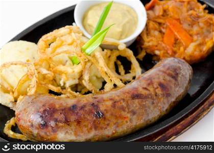 grilled frankfurter, potatoes, onion rings in batter, stewed cabbage and mustard