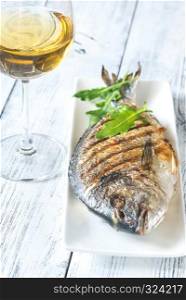 Grilled gilt-head bream on the plate