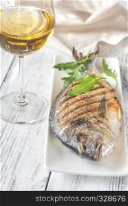 Grilled gilt-head bream on the plate