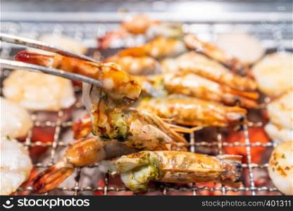 grilled japanese tiger prawn and hokkaido scallop yakiniku with red hot charcoal