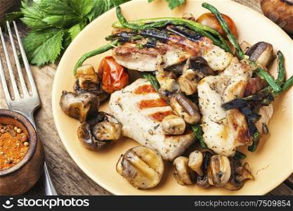 Grilled juicy steak with mushrooms on a plate. Delicious grilled meat