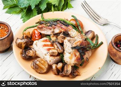 Grilled juicy steak with mushrooms on a plate. Grilled steak and spices