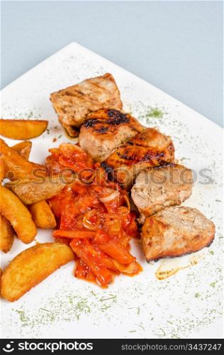 Grilled kebab pork meat with roasted potato and vegetables